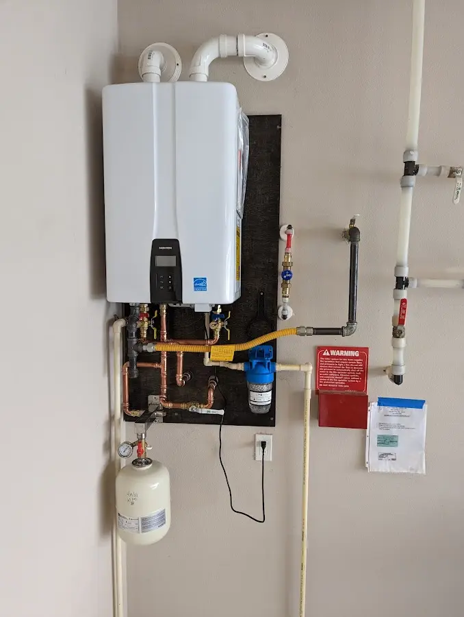 Professional plumber installing copper piping in a Ruston home